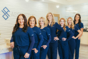A group of our female providers, all wearing blue scrubs, that practice cosmetic dermatology in Boone County, KY, at Dermatology Aesthetics of Northern Kentucky.