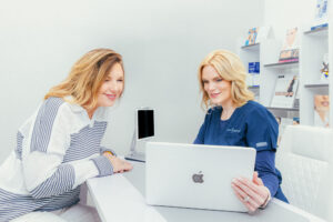 A Dermatology Aesthetics of Northern Kentucky providers discusses a female patient's options for facial rejuvenation treatment near Cincinnati, adjusting for the time of year and expected sun exposure.