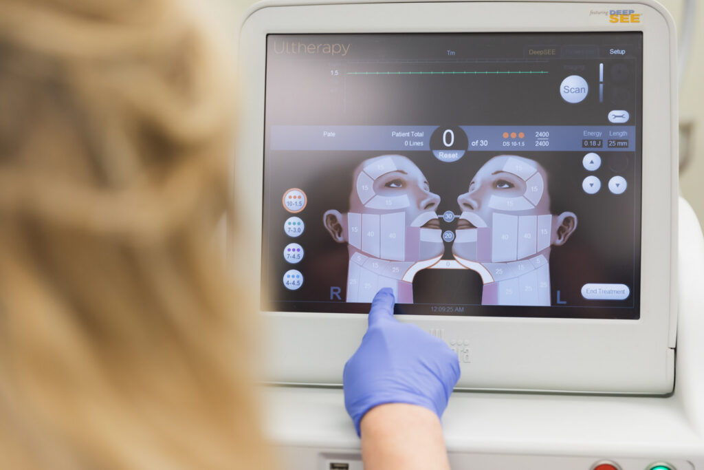 A female Dermatology Aesthetics of Northern Kentucky provider adjust the intensity of the ultrasound technology during Ultherapy near Cincinnati. 